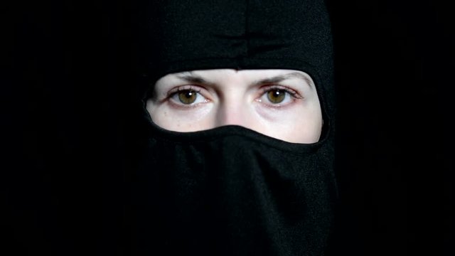 Girl offender. The girl in a black mask.