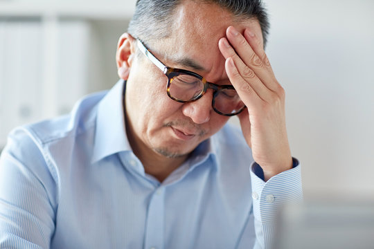 businessman suffering from headache at office