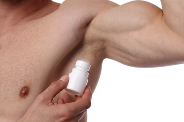 Man applying deodorant on armpit . Male putting antiperspirant stick on underarms
