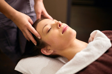 woman having head massage at spa