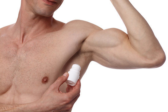 Man applying deodorant on armpit . Male putting antiperspirant stick on underarms