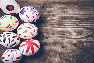 Easter Eggs on old boards. Painted eggs. Old board background. Easter ideas. Easter eggs. Space for text. Image in trendy toning.