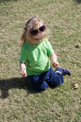 small baby boy with happy face on green grass