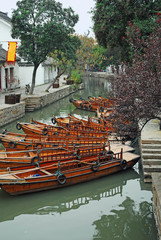 China, Shanghai water village Tongli. Boats for tourist display at the village entry point.