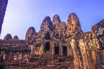 Fototapeta na wymiar October 11, 2014: Stone faces of the temple of Bayon in the Angkor Wat temple complex near Siem Reap, Cambodia