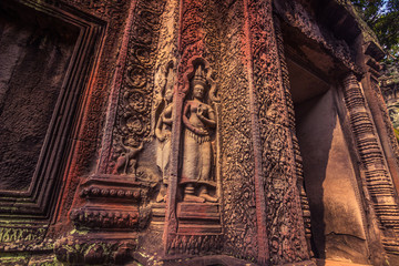 October 11, 2014: Buddhist details of a carved wall in the Ta Prohm temple in Siem Reap, Cambodia