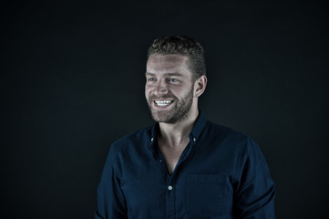 handsome happy man with unshaven face in blue fashionable shirt