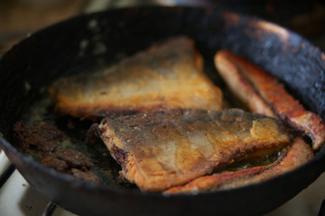 Fried fish on black frying pan