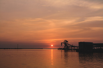 Fototapeta na wymiar Ship loader sunset silhouette
