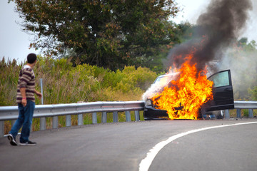 Car on fire with passengers