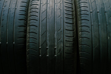 Fototapeta premium Car tires on the service place. Low light image.