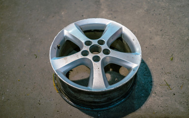 Dirty car wheel disk on the service. Low light image