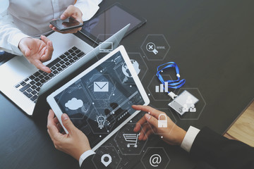 co working team meeting concept,businessman using smart phone and digital tablet and laptop computer and name tag in modern office