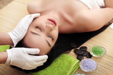 Obraz na płótnie Canvas Spa. Young pretty woman enjoying face massage procedure.