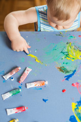 Babies hands painting colorful mosaic