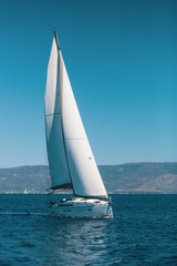 Fototapeta na wymiar Sailboat with sails set to Sea at full speed. Luxury cruise yacht.