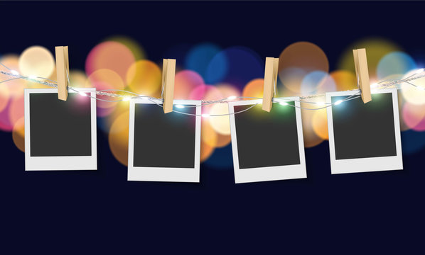 Hanging blank photo frame on soft bokeh and lights background