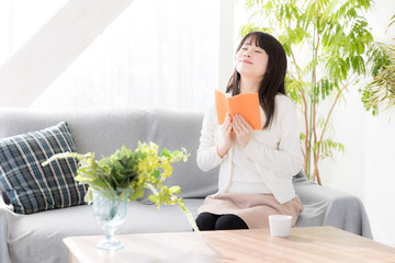 attractive asian woman relaxing in living room