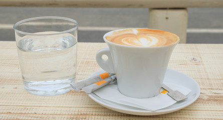 Cup of capuccino on a wooden table