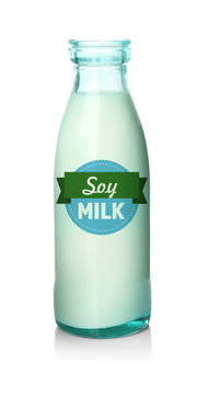 Glass bottle of tasty milk on white background