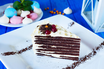 Piece of chocolate layered cake with butter cream