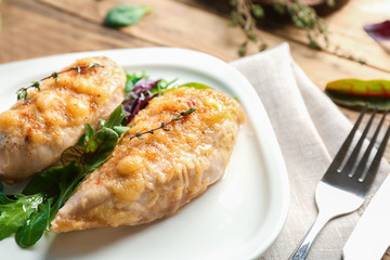 Delicious chicken breasts with arugula on plate