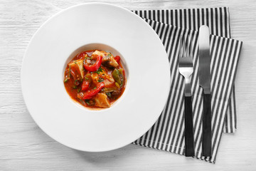 Plate with tasty chicken cacciatore on table