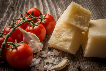 Pecorino and cherry tomatoes on rustic wooden table