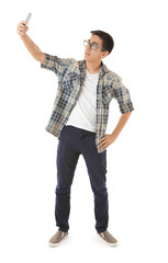 Young Asian man taking selfie on white background