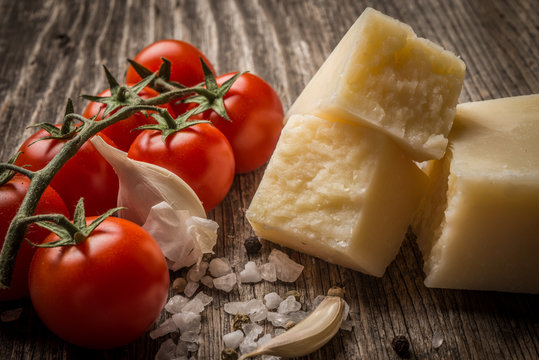 Pecorino and cherry tomatoes on rustic wooden table
