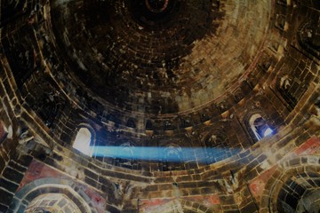 A dome lit up by the afternoon sun, with a singular point of light.