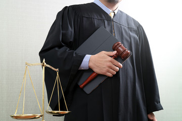 justice and law concept.Male judge in a courtroom with the gavel and balance scale and holy book...