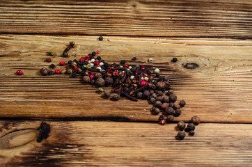 Different pepper spices on wooden table