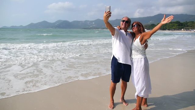 Senior Couple Taking Selfie with Smartphone on Beach