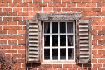 anceint wooden window and brick wall