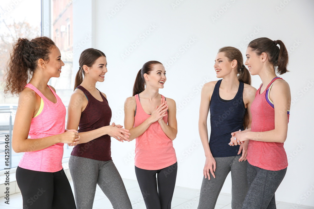 Wall mural young sporty women talking at training