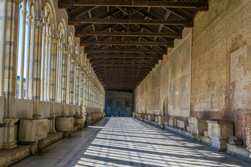 view of a corridor of the camposanto cemetery in Pisa, Italy