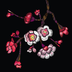 Embroidered flowering branch. Cherry branch, apple or sakura with flowers and buds on a black background.
