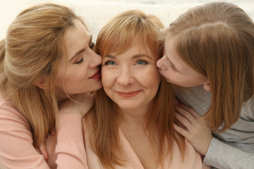 Happy mature woman with her family at home