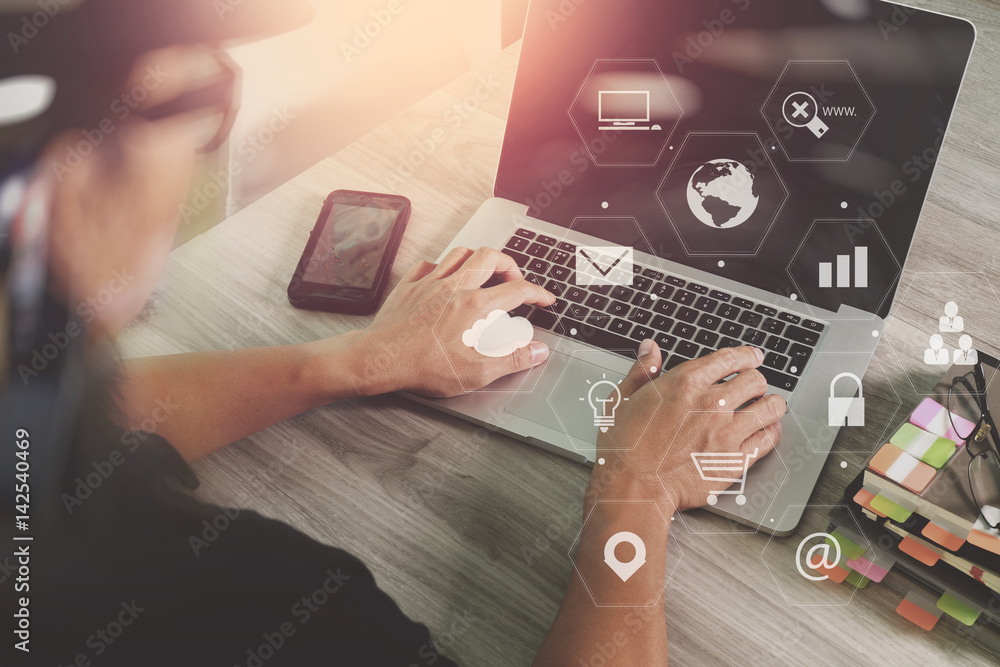 Poster businessman working with smart phone and laptop computer on wooden desk in modern office with virtua