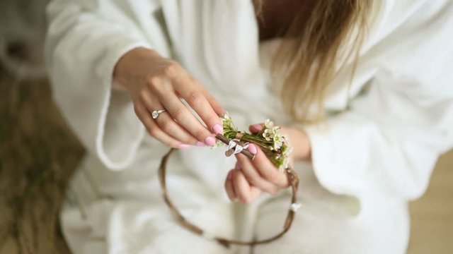 The bride in a white hotel gown wove a wreath of gypsophila.