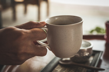 Hot coffee latte or black coffee in the coffee shop, vintage color filter.