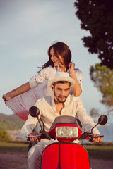 Couple in love riding a motorbike , Handsome guy and young sexy woman travel .