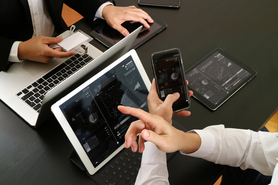 co working team meeting concept,businessman using smart phone and digital tablet and laptop computer and name tag in modern office