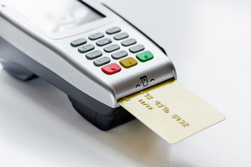 payment terminal with card on table background