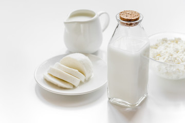 monochrome concept with dairy products on white table