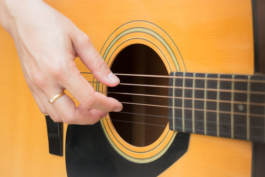 Guitarist Hand Playing Acoustic Guitar