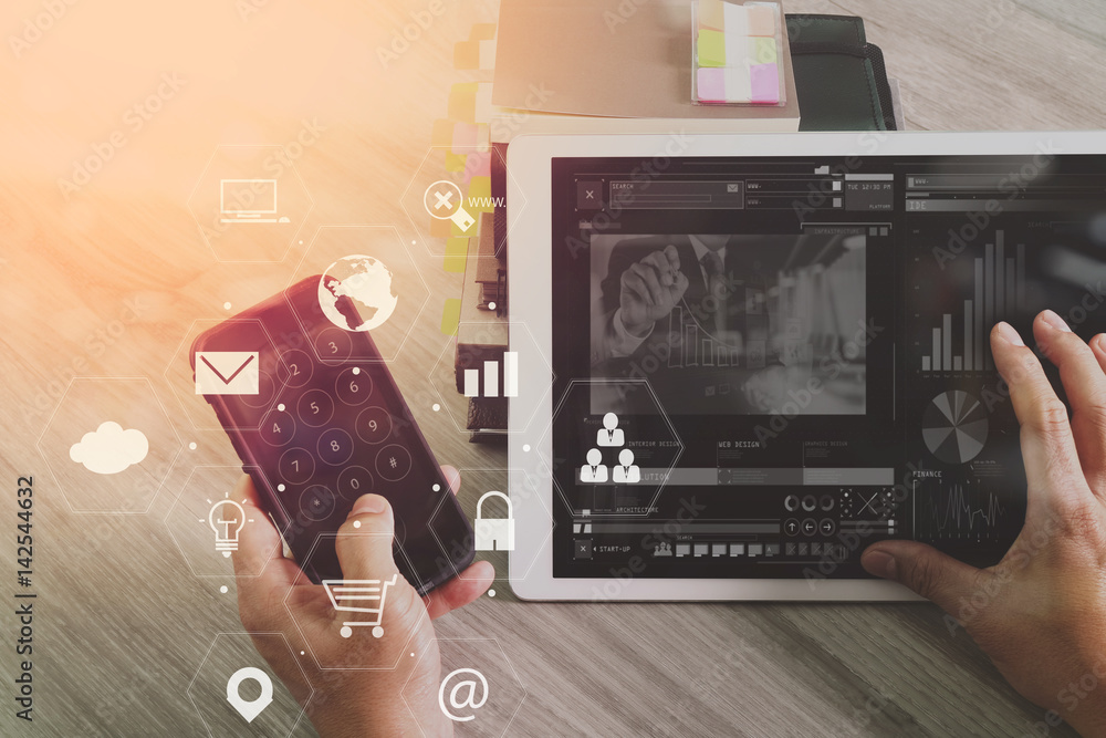 Poster businessman working with smart phone and digital tablet computer on wooden desk in modern office with virtual icons interface