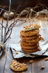 Homemade cookies with a peanut on paper for pastries on wooden table. Selective focus.