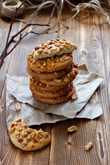 Homemade cookies with a peanut on paper for pastries on wooden table. Selective focus.
